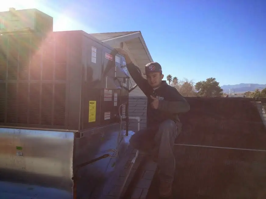HVAC technician performing Boiler Repair on a rooftop unit in New Sewickley